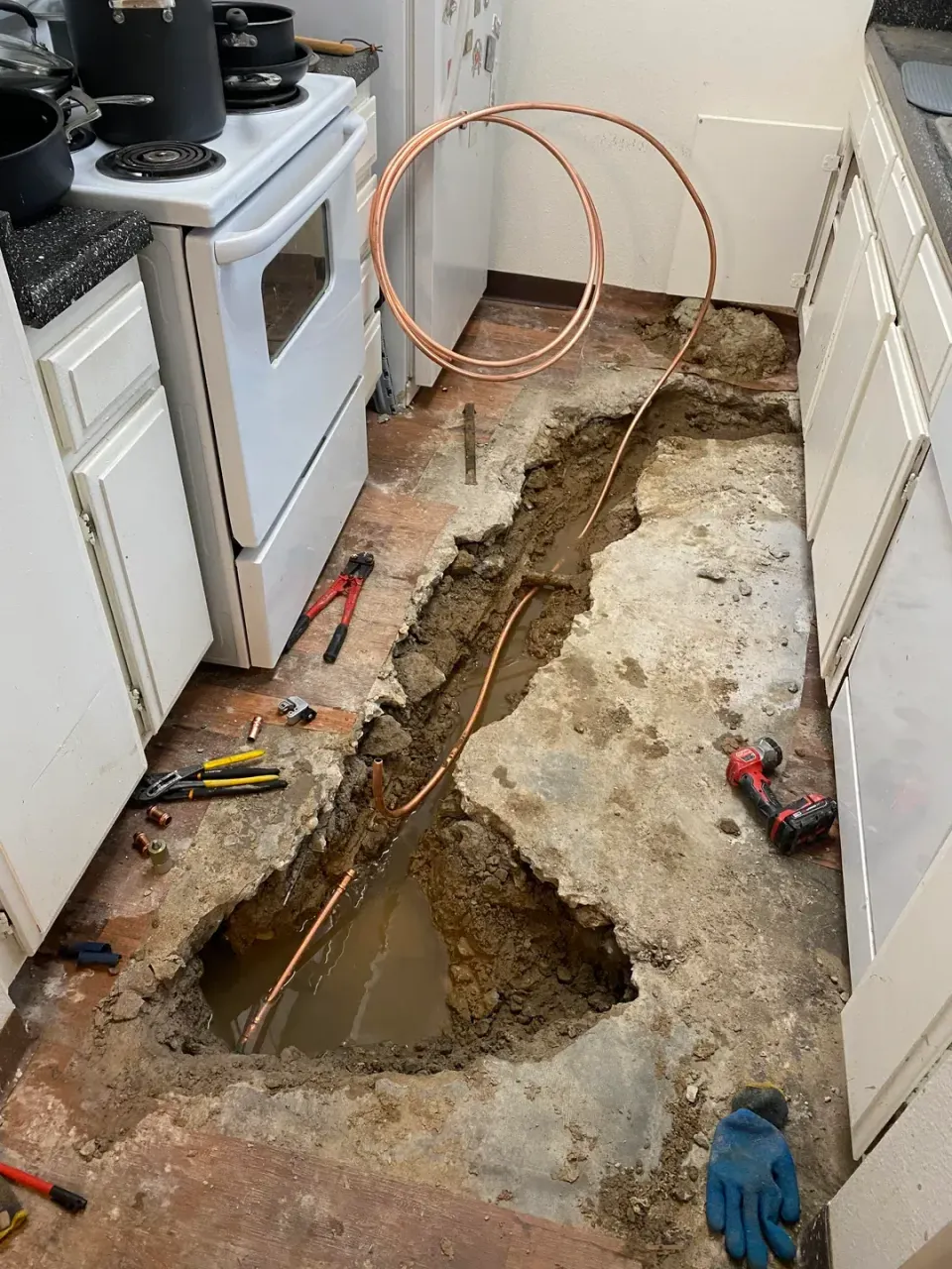 A pipe is leaking water into a basement.