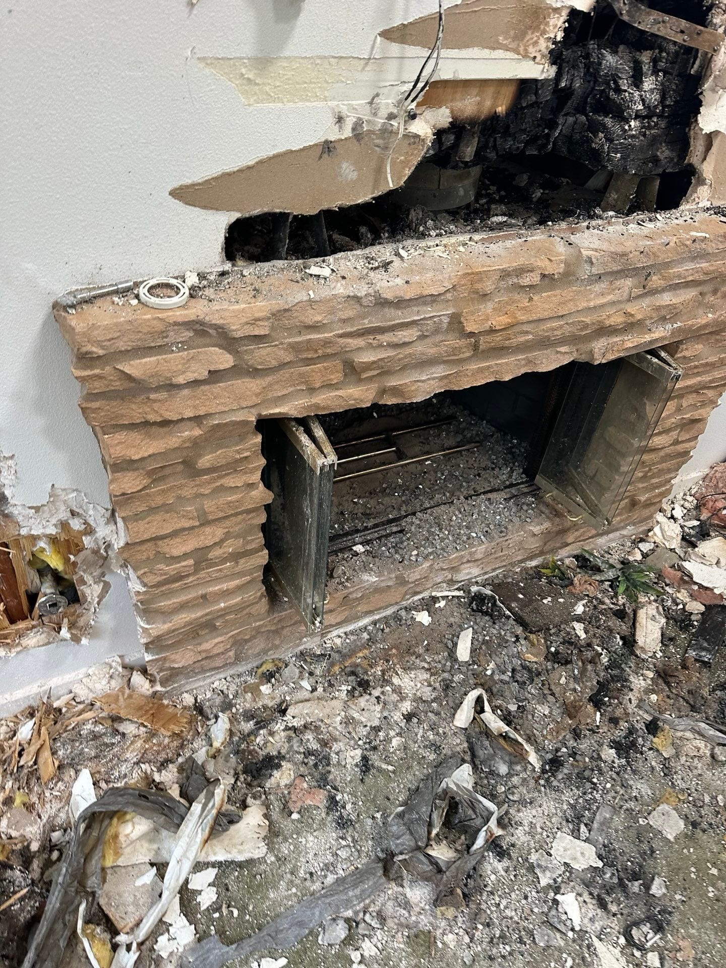 A brick fireplace is being demolished in a house in Huntington Beach.