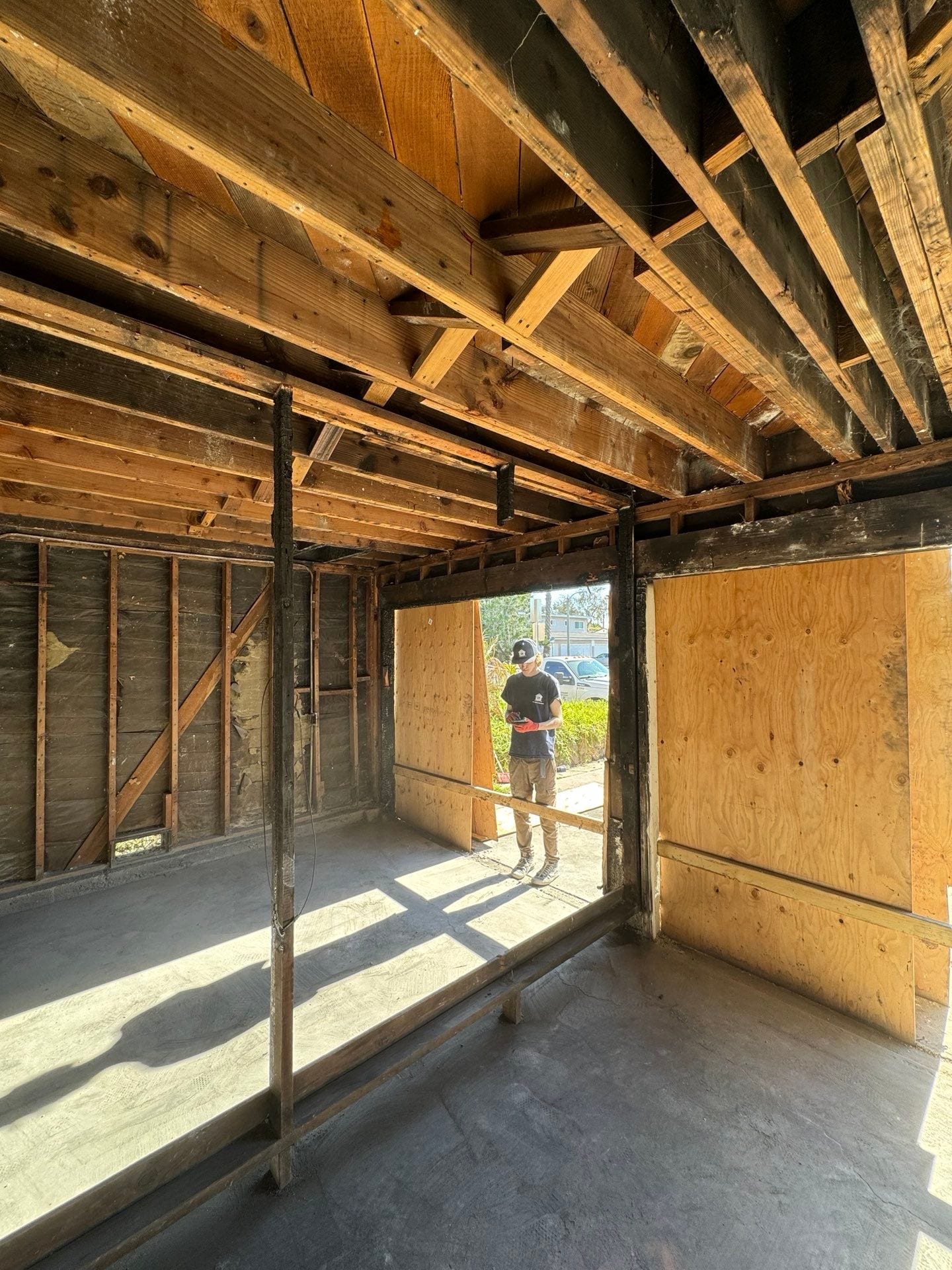 A man is standing in an empty room in a house under construction in Huntington Beach.