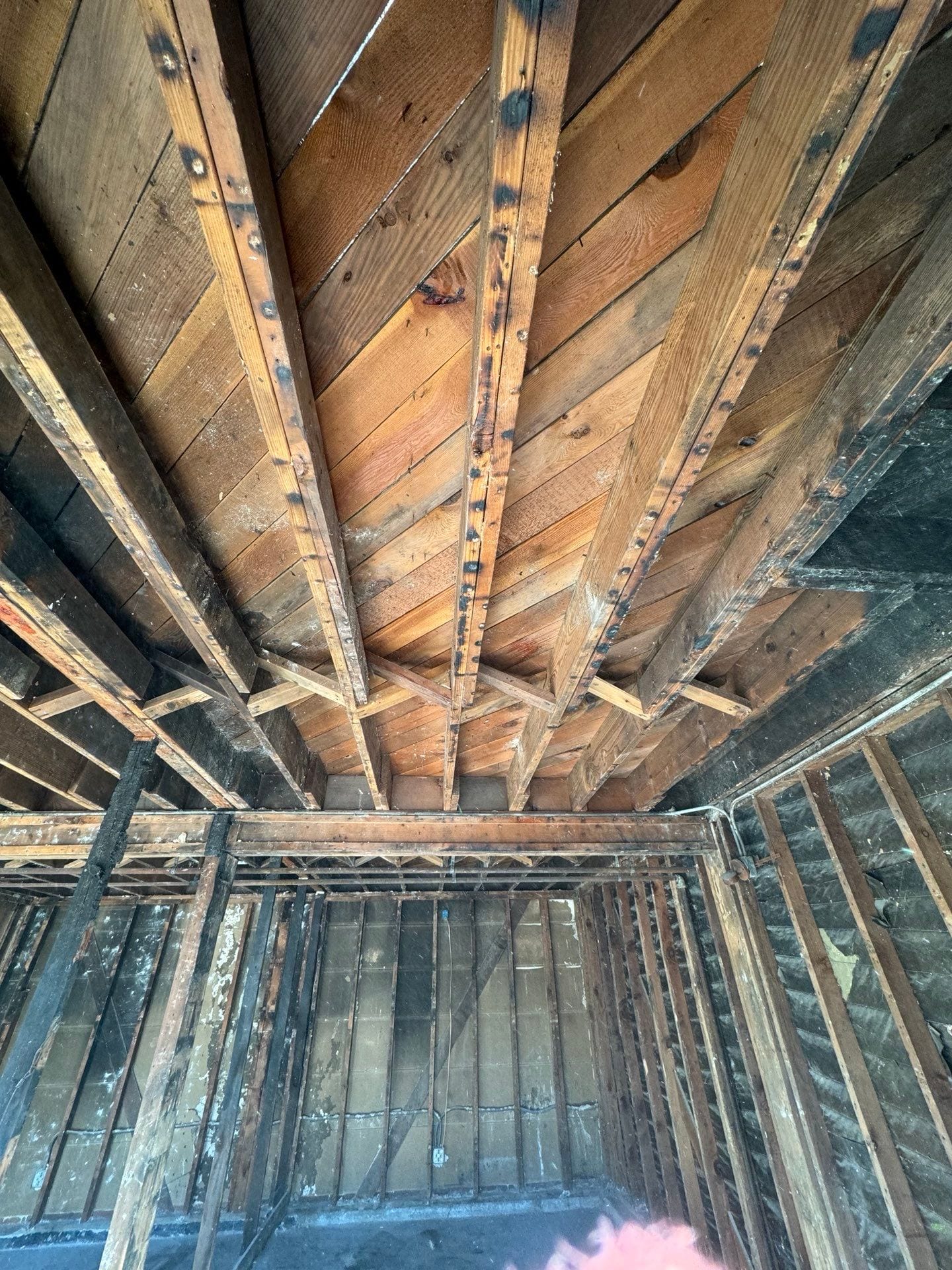 Looking up at the ceiling of a building with wooden beams in Huntington Beach.
