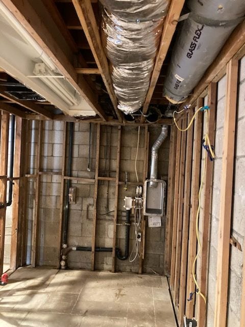 Room demolished down to the studs, with ductwork and plumbing exposed overhead.