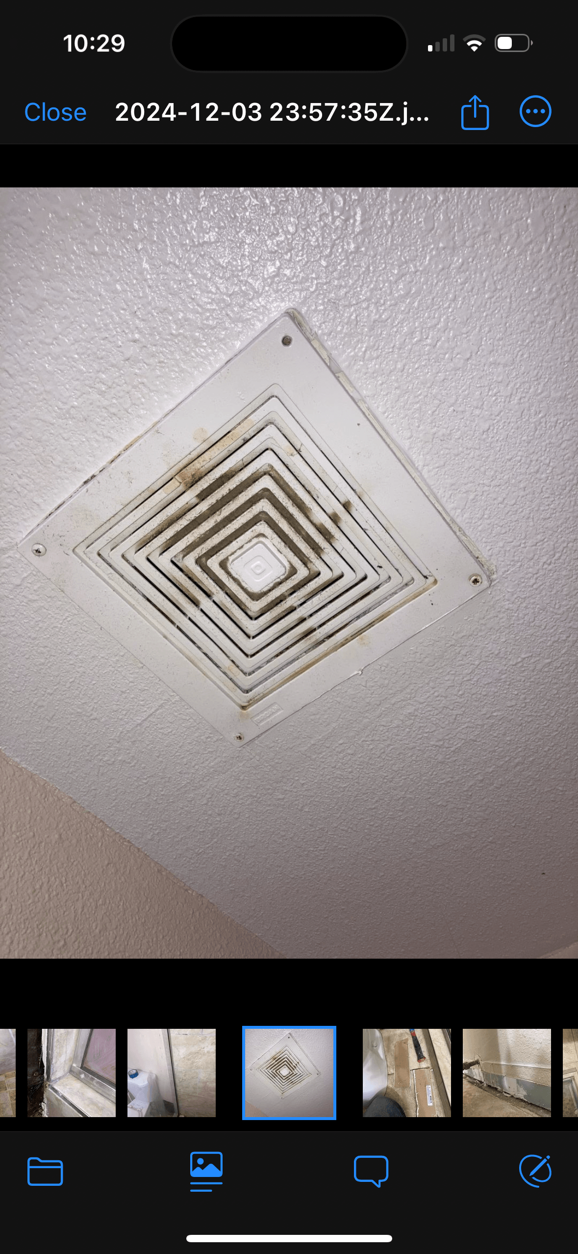 A picture of a ceiling fan on a cell phone.