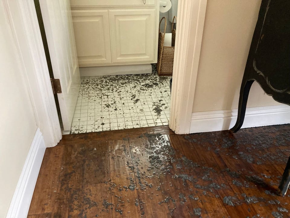 A bathroom with a dirty floor and a sink.